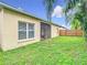 Exterior view of home's back yard and lanai showcasing the yard and fence at 4981 Waterside Pointe Cir, Orlando, FL 32829