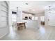 Open dining area with white walls, light wood flooring, and ample space for entertaining guests at 4981 Waterside Pointe Cir, Orlando, FL 32829