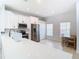 Bright kitchen area with white cabinets, stainless steel appliances, and a cozy breakfast nook at 4981 Waterside Pointe Cir, Orlando, FL 32829