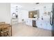 An open-concept kitchen featuring white cabinets, stainless steel appliances, and views into the dining area at 4981 Waterside Pointe Cir, Orlando, FL 32829