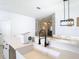 A stylish kitchen with a farmhouse sink, modern faucet, and bright white countertops at 4981 Waterside Pointe Cir, Orlando, FL 32829