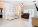 Bright living room with modern flooring, ceiling fan, and a sliding glass door to the backyard at 4981 Waterside Pointe Cir, Orlando, FL 32829