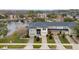 Aerial view of townhomes overlooking a serene pond and lush landscaping at 5409 Caramella Dr, Orlando, FL 32829