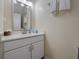 Clean bathroom features a white vanity with a sink and a decorative mirror at 5409 Caramella Dr, Orlando, FL 32829