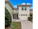 Charming two-story townhouse with a one car garage and inviting front porch at 5409 Caramella Dr, Orlando, FL 32829