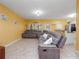 Comfortable living room with a large sectional sofa and tile flooring throughout the area at 5409 Caramella Dr, Orlando, FL 32829