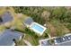 Overhead shot of a community pool with lounge chairs, palm trees, and nearby parking at 5409 Caramella Dr, Orlando, FL 32829