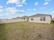 Exterior view of the home showcasing a spacious backyard with a fence at 5654 Winona Dr, St Cloud, FL 34771