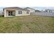 Exterior backyard view of the home featuring a covered lanai with a seating area at 5654 Winona Dr, St Cloud, FL 34771