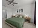 Stylish bedroom features a green color scheme, ceiling fan, and two nightstands with lamps at 5654 Winona Dr, St Cloud, FL 34771