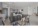 Modern dining room with a view of the kitchen is equipped with stainless steel appliances and granite countertops at 5654 Winona Dr, St Cloud, FL 34771