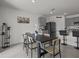 Dining room features a modern table set, stylish decor, and seamless connection to the adjacent open-concept kitchen at 5654 Winona Dr, St Cloud, FL 34771