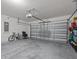 Garage with a large door, cement floors, high ceilings, and storage shelves at 5654 Winona Dr, St Cloud, FL 34771