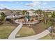 Community playground showcases recreational space with fencing and mature trees at 5654 Winona Dr, St Cloud, FL 34771