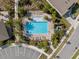 Aerial view of a community pool with lounge chairs, palm trees, and parking at 5654 Winona Dr, St Cloud, FL 34771