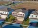 Aerial view of a two-story home featuring a brick driveway and an attached two-car garage at 613 Bloom Ter, Davenport, FL 33837