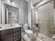 Bathroom featuring a glass enclosed shower, vanity, and neutral color walls with grey tiled floors at 613 Bloom Ter, Davenport, FL 33837