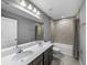 Bathroom features double sinks, a large mirror, and a tiled shower and tub combination at 613 Bloom Ter, Davenport, FL 33837