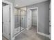 Bathroom with tile flooring, glass enclosed shower with built in bench, and walk-in closet at 613 Bloom Ter, Davenport, FL 33837