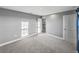 Bedroom features soft gray walls, plush carpet, and bright, natural light at 613 Bloom Ter, Davenport, FL 33837