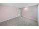 Spacious bedroom featuring soft pink walls, plush carpet, and ample natural light at 613 Bloom Ter, Davenport, FL 33837