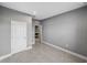 Neutral-painted bedroom with tiled floors leading to a kitchen with stainless steel microwave and cabinets at 613 Bloom Ter, Davenport, FL 33837