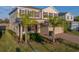 Two-story home featuring tan siding, red shutters, a brick driveway and an attached two-car garage at 613 Bloom Ter, Davenport, FL 33837