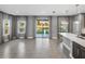 Open concept living room flowing into the kitchen with a large island and modern pendant lighting at 613 Bloom Ter, Davenport, FL 33837