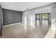 Spacious living area with grey accent wall and a seamless transition to other living spaces at 613 Bloom Ter, Davenport, FL 33837