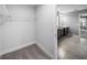 Carpeted walk-in closet featuring metal shelving and an entrance to the bathroom with tile flooring and double sink vanity at 613 Bloom Ter, Davenport, FL 33837