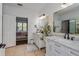 Bathroom featuring double sinks, elegant mirrors, and stylish decor at 6443 Axeitos Ter # 105, Orlando, FL 32835