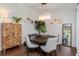 Dining area featuring a modern chandelier, round table, and stylish accents at 6443 Axeitos Ter # 105, Orlando, FL 32835