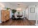 Bright dining room with wood floors, round table, and chandelier lighting at 6443 Axeitos Ter # 105, Orlando, FL 32835