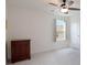 Empty bedroom with a ceiling fan, window, and a chest of drawers against the wall at 739 Annabell Ridge Rd, Minneola, FL 34715