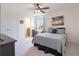 Comfortable bedroom with a ceiling fan, window with natural light, and attached bathroom at 739 Annabell Ridge Rd, Minneola, FL 34715