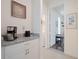 Hallway features granite counters, white cabinets, and natural light streaming through open doorways at 739 Annabell Ridge Rd, Minneola, FL 34715