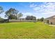 Grassy backyard with privacy fence, providing ample space for outdoor activities and relaxation at 817 Sheen Cir, Haines City, FL 33844