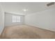 Bright bedroom featuring neutral carpet, white walls, and a window for natural light at 817 Sheen Cir, Haines City, FL 33844