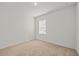 Cozy carpeted bedroom featuring a window and neutral paint, perfect for relaxation at 817 Sheen Cir, Haines City, FL 33844