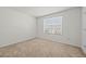 Bedroom with a window offering natural light, neutral carpet, and freshly painted walls at 817 Sheen Cir, Haines City, FL 33844