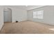 Carpeted bedroom featuring a window for natural light and an entrance to a hallway at 817 Sheen Cir, Haines City, FL 33844