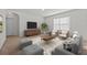 Cozy living room featuring comfortable seating, a decorative rug, and ample natural light from a large window at 817 Sheen Cir, Haines City, FL 33844