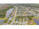 Scenic aerial view of a residential area with a lake and lush vegetation at 10068 Chardonnay Dr, Orlando, FL 32832