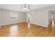 Spacious bedroom with beautiful wood floors, a ceiling fan, and a window for ample natural light at 10068 Chardonnay Dr, Orlando, FL 32832