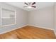 Cozy bedroom with a ceiling fan and wood flooring at 10068 Chardonnay Dr, Orlando, FL 32832