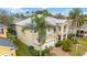 Two-story home with manicured landscaping and a spacious driveway, enhanced by mature palm trees at 10068 Chardonnay Dr, Orlando, FL 32832