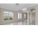 Bright foyer with soaring ceilings, white columns, gorgeous tile floor and glass front door at 10068 Chardonnay Dr, Orlando, FL 32832