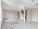 Bright living room with soaring ceilings, white columns, gorgeous tile floor and stairway access at 10068 Chardonnay Dr, Orlando, FL 32832