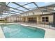 Spacious screened-in pool area perfect for outdoor entertaining and relaxation with fenced backyard views at 10068 Chardonnay Dr, Orlando, FL 32832