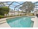 Relaxing screened pool area with lush landscaping for privacy and a refreshing oasis at 10068 Chardonnay Dr, Orlando, FL 32832